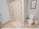 Full bathroom with a toilet, shower with patterned curtain, and humorous bath mat at 82 Idlewood Ln, Clayton, NC 27527