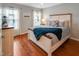 Well-lit bedroom featuring a comfortable bed, light gray walls, and wood flooring at 82 Idlewood Ln, Clayton, NC 27527