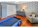 Charming bedroom with wood flooring, unique wallpaper, and comfortable furnishings at 82 Idlewood Ln, Clayton, NC 27527