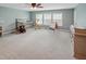 Bedroom with soft blue walls, carpet, crib, easel, dresser, and decorative giraffe at 82 Idlewood Ln, Clayton, NC 27527