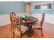 Elegant dining room features a round wooden table, ornate chairs, and a decorative mirror reflecting the space at 82 Idlewood Ln, Clayton, NC 27527