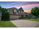 Charming two-story home boasting a manicured lawn, stone accents, and attached two-car garage at 82 Idlewood Ln, Clayton, NC 27527