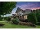 Charming two-story home with beautiful landscaping, stone accents, and lush greenery at 82 Idlewood Ln, Clayton, NC 27527