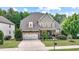 Charming two-story home featuring a well-manicured lawn, stone accents, and an attached two-car garage at 82 Idlewood Ln, Clayton, NC 27527