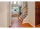 Welcoming foyer with hardwood floors, a staircase with iron spindles, and a view of the front door at 82 Idlewood Ln, Clayton, NC 27527