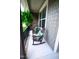 Charming front porch featuring rocking chairs and a table with vibrant pillows, perfect for relaxing outdoors at 82 Idlewood Ln, Clayton, NC 27527
