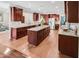 Open kitchen boasts an island, granite countertops, stainless steel appliances, and beautiful wood flooring at 82 Idlewood Ln, Clayton, NC 27527