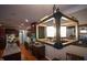 Open kitchen view with island, stainless steel appliances, gas range, and stylish overhead lighting at 82 Idlewood Ln, Clayton, NC 27527