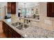 Modern kitchen featuring granite countertops, stainless steel sink, and a clear view into the living room at 82 Idlewood Ln, Clayton, NC 27527