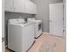 Functional laundry room with modern washer, dryer, and ample cabinet space at 82 Idlewood Ln, Clayton, NC 27527