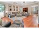 Spacious living room with hardwood floors, large sectional sofa, and stylish chandeliers at 82 Idlewood Ln, Clayton, NC 27527