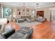 Spacious living room featuring contemporary decor, hardwood flooring, and multiple chandeliers at 82 Idlewood Ln, Clayton, NC 27527