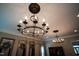 Elegant chandeliers illuminate this living room with crown molding and custom shelving at 82 Idlewood Ln, Clayton, NC 27527
