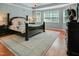 Tranquil main bedroom with hardwood floors, a plush rug, and natural light at 82 Idlewood Ln, Clayton, NC 27527