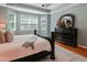 Cozy main bedroom showcasing a large window and stylish dresser at 82 Idlewood Ln, Clayton, NC 27527