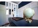 Close-up of desk featuring decorative globe and clock, complemented by custom built-ins with mirrored doors at 82 Idlewood Ln, Clayton, NC 27527