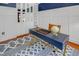 Stylish office with a navy accent wall, built-in shelving, modern desk, and eye-catching patterned rug at 82 Idlewood Ln, Clayton, NC 27527