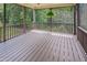 Cozy screened porch offers a relaxing space with nature views and a hanging fern at 82 Idlewood Ln, Clayton, NC 27527