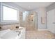 Bathroom with a tiled shower, soaking tub, and tile flooring at 821 Laurel Garden Way, Cary, NC 27513