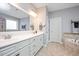 Elegant bathroom featuring double vanity, large mirror, and soaking tub at 821 Laurel Garden Way, Cary, NC 27513