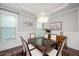 Formal dining room with wainscoting, chandelier, and plenty of natural light at 821 Laurel Garden Way, Cary, NC 27513