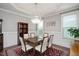 Elegant dining room featuring a modern chandelier and ample natural light at 821 Laurel Garden Way, Cary, NC 27513