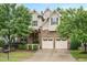 Charming two-story home with stone accents, a two-car garage, and mature landscaping at 821 Laurel Garden Way, Cary, NC 27513