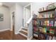 Hallway with hardwood floors, a staircase, and a bookshelf at 821 Laurel Garden Way, Cary, NC 27513