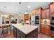 Well-appointed kitchen with large island, stainless steel appliances, and easy access to dining and living areas at 821 Laurel Garden Way, Cary, NC 27513