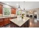 Open-concept kitchen boasts an island, stainless appliances, and seamless flow to the living room at 821 Laurel Garden Way, Cary, NC 27513
