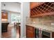 Wet bar boasts wine rack, beverage fridge, stone backsplash, and stone counter at 821 Laurel Garden Way, Cary, NC 27513
