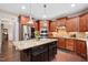 Gourmet kitchen showcasing a large island, custom cabinetry, and stainless steel appliances at 821 Laurel Garden Way, Cary, NC 27513
