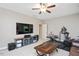 Living room featuring a TV, cabinets, exercise equipment, and comfortable furniture at 821 Laurel Garden Way, Cary, NC 27513