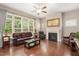 Spacious living room featuring a fireplace, large windows, and wood floors at 821 Laurel Garden Way, Cary, NC 27513