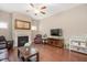 Cozy living room with a fireplace, ceiling fan, and views of the backyard at 821 Laurel Garden Way, Cary, NC 27513