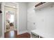 Hallway with a wall-mounted shelf, hooks, and a wooden bench with metal baskets at 821 Laurel Garden Way, Cary, NC 27513