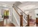 Elegant staircase with wood and white accents leads to a formal dining room at 821 Laurel Garden Way, Cary, NC 27513
