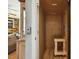 Interior view of elevator, featuring wood paneled walls and floors, with a small bench at 8437 Charlie Stovall Rd, Oxford, NC 27565