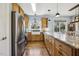 Spacious kitchen featuring stainless steel appliances, a large island, ample cabinet space, and hardwood floors at 8437 Charlie Stovall Rd, Oxford, NC 27565