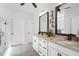 Elegant bathroom featuring dual sinks, granite countertops, stylish mirrors, and modern fixtures and finishes at 901 Del Webb Manor Ave, Wake Forest, NC 27587