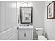 Charming half-bath featuring a white vanity with marble countertop, framed mirror and toilet at 901 Del Webb Manor Ave, Wake Forest, NC 27587