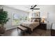 Comfortable bedroom featuring neutral colors, a ceiling fan, and natural light through large windows with plantation shutters at 901 Del Webb Manor Ave, Wake Forest, NC 27587