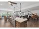 Open-concept kitchen flows into living and dining areas, with a large island and modern fixtures at 901 Del Webb Manor Ave, Wake Forest, NC 27587