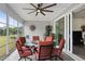 Inviting sunroom with comfortable seating, ceiling fan, and tranquil outdoor views through large sliding glass doors at 901 Del Webb Manor Ave, Wake Forest, NC 27587