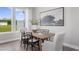 Bright dining room featuring hardwood floors, natural light, and a stylish decor at 910 Kensley Grove Ln # 70, Fuquay Varina, NC 27526
