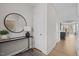 Hallway entrance featuring sleek console table, round mirror, and contemporary decor at 910 Kensley Grove Ln # 70, Fuquay Varina, NC 27526