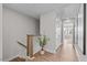 Upstairs hallway features hardwood floors, staircase, neutral walls and a plant in a pot at 910 Kensley Grove Ln # 70, Fuquay Varina, NC 27526