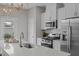 Modern kitchen with white cabinets, stainless steel appliances, and a quartz countertop island at 910 Kensley Grove Ln # 70, Fuquay Varina, NC 27526