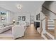 Bright living room features hardwood floors, neutral walls, staircase, and stylish decor at 910 Kensley Grove Ln # 70, Fuquay Varina, NC 27526