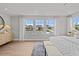 Spacious primary bedroom boasts carpet, lots of windows, ceiling fan, and stylish decor at 910 Kensley Grove Ln # 70, Fuquay Varina, NC 27526